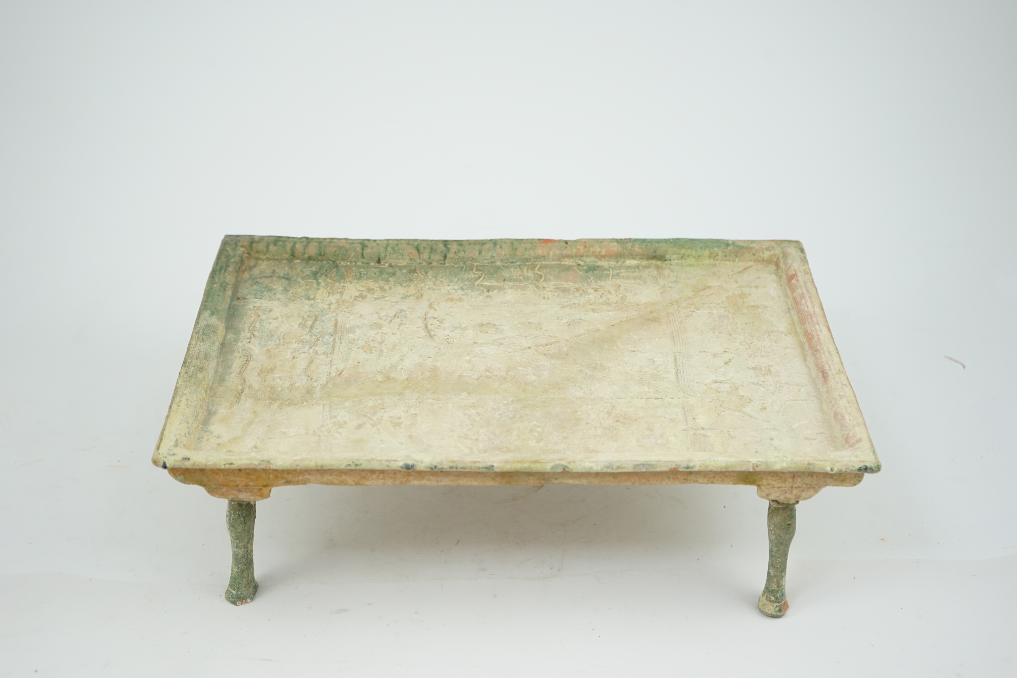 A rare Chinese glazed decorated pottery table with legs, Han Dynasty (206 BC-AD 220).